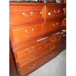 A 2 over 3 chest of drawer and a pair of matching bedside chests,.