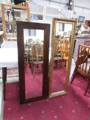 A gilt framed mirror and one other.