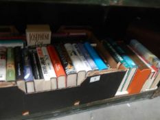 A shelf of mainly hardback books.