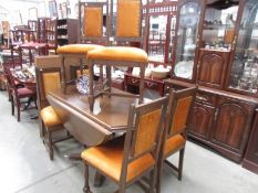 An oak dining table and 6 chairs.