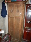 An arts and crafts oak wardrobe,