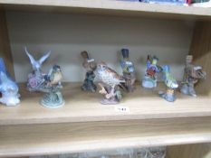 A shelf of bird figures.