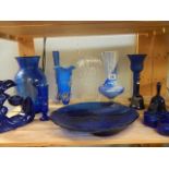 A shelf of blue glass ware.