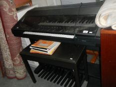 A Yamaha organ, stool and music.