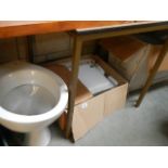 A new modern wash basin and 2 toilets.