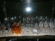 A shelf of assorted glass ware.