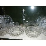 A shelf of glassware including bowls, commemorative plates, cake stand etc.