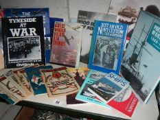 A shelf of mainly war related books and magazines.