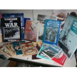 A shelf of mainly war related books and magazines.