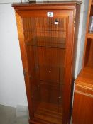 A glazed CD/DVD cabinet.