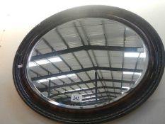 An oval framed mirror.