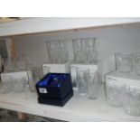 A shelf of boxed glass tumblers.