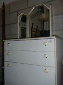 A white 3 drawer chest and mirror.