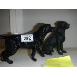 2 black Labrador figures.