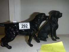 2 black Labrador figures.