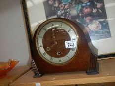 An oak mantel clock.