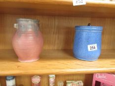 A Royal Doulton stoneware tobacco jar and an Upchurch pottery vase.