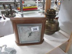 A brass oil lamp font and a barometer.