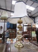 A brass table lamp with shade.