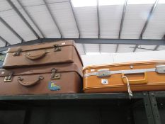 3 vintage suitcases.