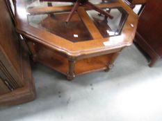 An octagonal glass topped coffee table.