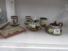 7 pieces of Torquay motto ware including teapot, candlesticks etc.