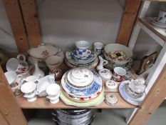 A shelf of assorted china including commemorative, plates, dishes etc.