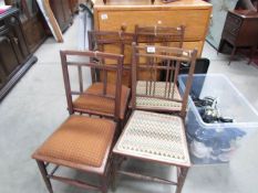 A pair of inlaid chairs and another pair of chairs.
