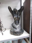 A large mermaid figure.