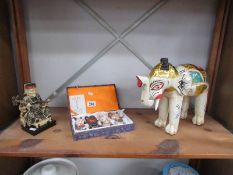 An elephant figure A/F, a figure of an Emperor and boxed miniature Chinese teapots.