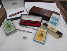 A mixed lot including Parker Pens, tie press, playing cards etc.