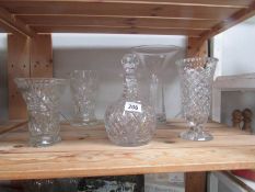 6 glass vases and a decanter.