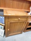 A light oak cupboard with open back,