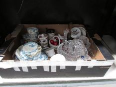 A box of assorted glass and china.
