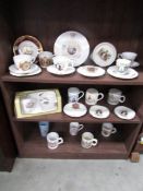 3 shelves of commemorative china.