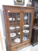 A Lead glazed oak display cabinet.