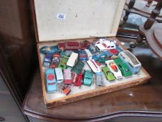 A wooden box of playworn Dinky, Corgi and Matchbox toys.