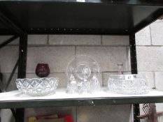 A shelf of assorted glass ware.