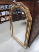 An arched bevel edged mirror.
