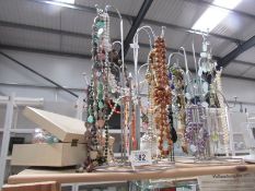 A mixed lot of necklaces, scent bottle etc.