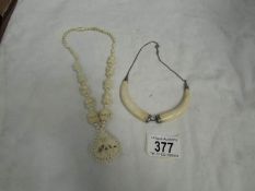 2 white necklaces with white metal fittings.