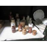 A quantity of small stoneware bottles.