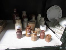 A quantity of small stoneware bottles.