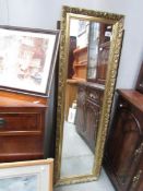 A gilt framed mirror and one other.