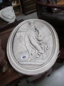 An oval classical wall plaque.