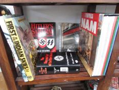 A shelf of war related books, German, Vietnam etc.
