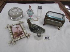 A French gilt and bevelled glass trinket box, a figure tape measure, glass inkwell etc.
