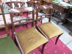 A pair of brass inlaid chairs.