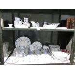 2 shelves of blue and white table ware,