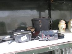 A quantity of camera's and a pair of binoculars.